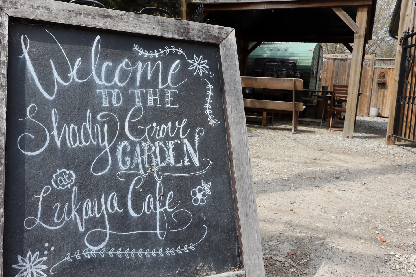 The garden entrance and chalkboard outside Lukaya Cafe