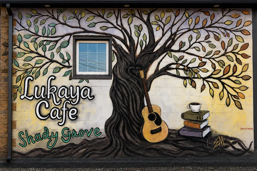 The tree-and-guitar mural on the cafe wall facing the Green P lot